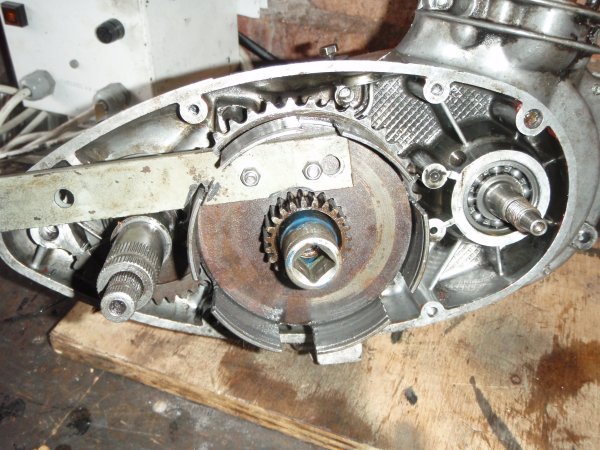 The tool prevents the centre from turning whilst you undo the retaining nut.